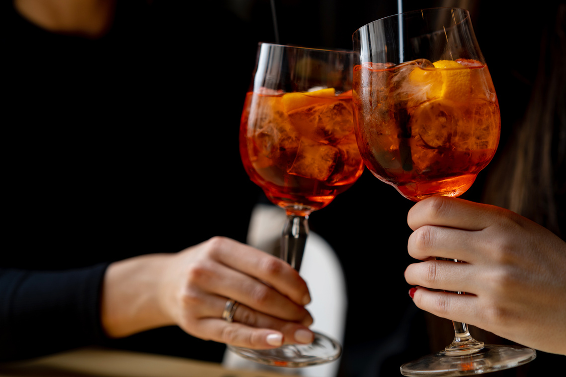 Toasting with aperol spritz cocktails