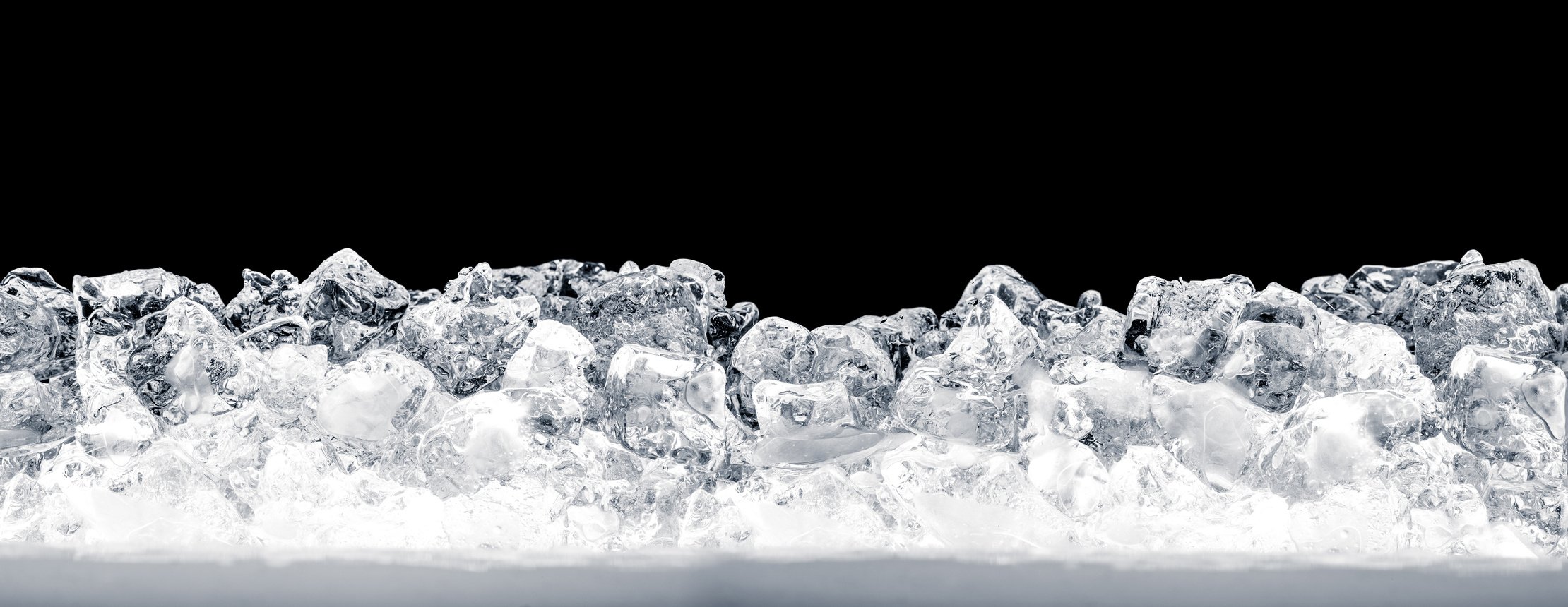 Illuminated ice cubes on black background.